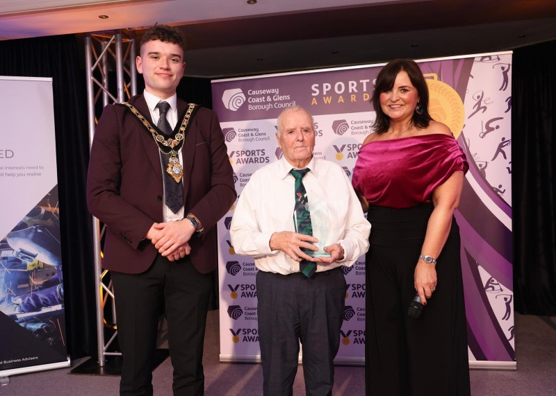 Mayor of Causeway Coast and Glens, Councillor Ciarán McQuillan presenting the ‘Services to Sport’ Award on behalf of Active Causeway, with Denise Watson and winner Samuel McNeill.