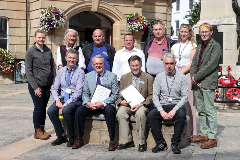 Back row (l-r)  Council staff Michelle McGrath (Health & Safety Support Officer), Jan O'Neill (Physical Regeneration Project Officer), Andy Scott (Estates Supervisor), Winston Brogan (Nursery Chargehand), John Simpson (Skilled Operative), Lisa Russell (Biodiversity and Habitat Management Officer), and Rodney Boyd (Gardener) Front row (l-r)  Noel Davoren (Estates Manager) Britain in Bloom judges Rae Beckwith and Roger Burnett pictured beside Damien Guy (Estates Supervisor)