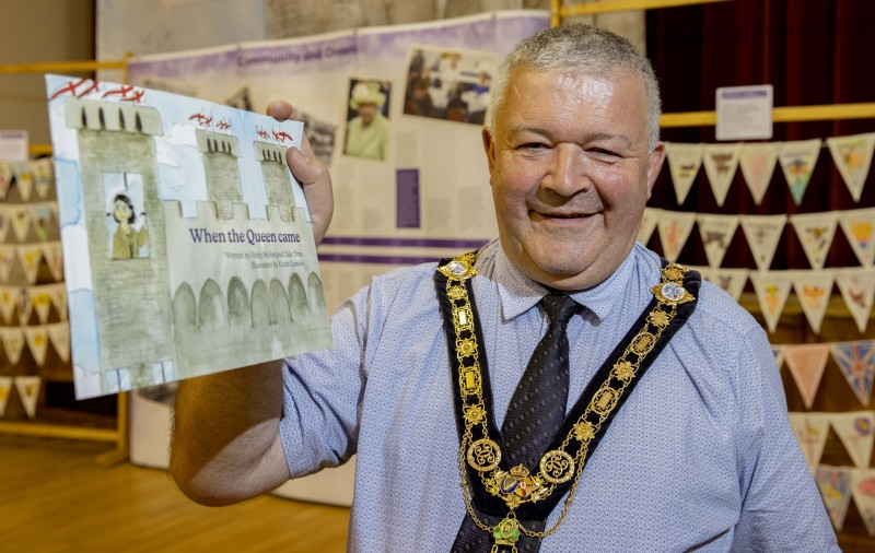 The Mayor of Causeway Coast and Glens Borough Council Councillor Ivor Wallace pictured with the new children’s storybook ‘When the Queen Came’ created as part of the Council’s Jubilee programme.