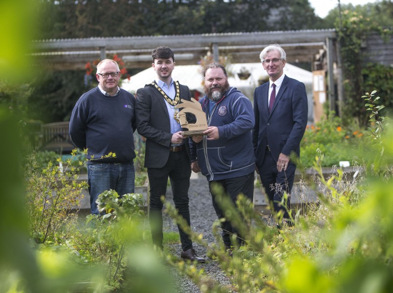 Patrick Frew from Cloughmills Community Action Team receives the European Week for Waste Reduction (EWWR) award from the Mayor of Causeway Coast and Glens Borough Council Councillor Sean Bateson, Environmental Resources Officer Declan Donnelly and Dr Ian Garner from the Waste and Resources Action Programme (WRAP).