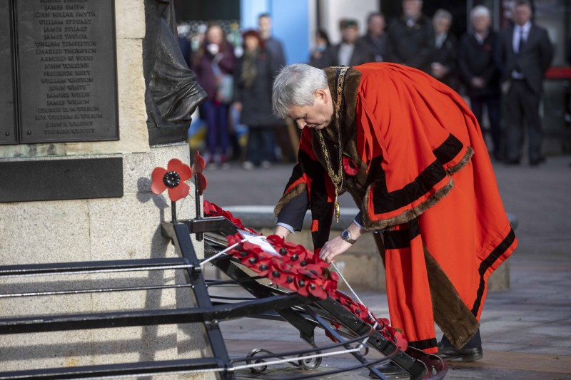 The Mayor of Causeway Coast and Glens Borough Council Councillor Richard Holmes lays a wreath at the War Memorial in Coleraine during a service to mark Armistice Day.