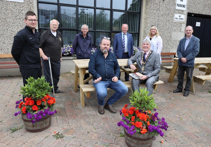 Pictured from left to right are Matthew Hagan, chef/proprietor of The Pepper Mill café and Chairperson of Dervock Young Defenders Flute Band, Scott Brown, resident of the village (former Submariner President of Dervock RBL), John Wilmot -resident of the village with 40 years of service with St John Ambulance, Frankie Cunningham - Chair of Dervock & District Community Association, Jim Allister MLA, Angela Mulholland, Outreach Worker - Building Communities Resource Centre and Keith Beattie, author & local historian.