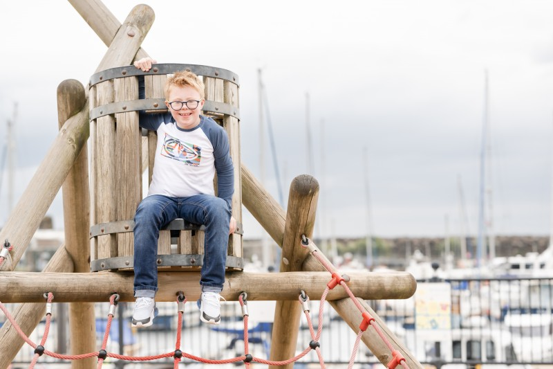 Lorcan McGonigle, who featured in the Summer Campaign by Council’s Destination Team, pictured enjoying the outdoor play facilities at Ballycastle Seafront.