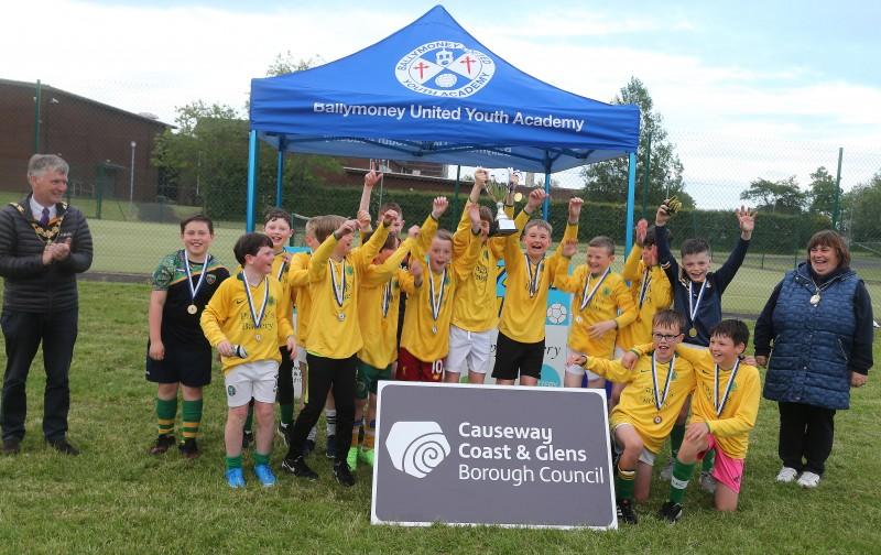 Dunloy FC, section 1 winners of Pappy’s Bakery Friendship Soccer League celebrate their success as the Mayor of Causeway Coast and Glens Borough Council Alderman Mark Fielding and the Mayoress, Mrs Phyllis Fielding, look on.