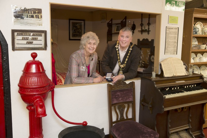 The Mayor of Causeway Coast and Glens Borough Council Councillor Richard Holmes presents one of Council’s Centenary Coin to Mrs Jennifer Gardiner on behalf of Garvagh Museum.