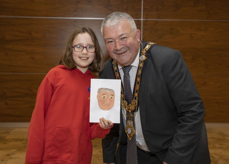 The Mayor of Causeway Coast and Glens Borough Council Councillor Ivor Wallace pictured with Evie Nicholl who painted this impressive portrait of the Mayor.