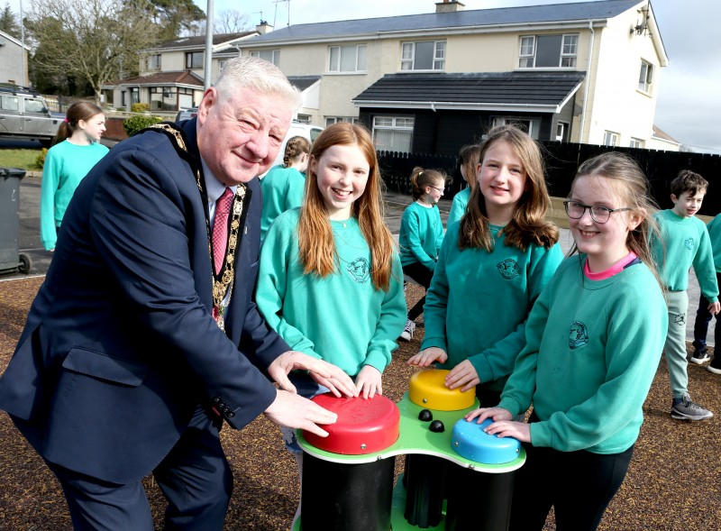 Mayor of Causeway Coast and Glens Councillor Steven Callaghan joins with children from St Patrick’s and St Joseph’s PS Garvagh as they enjoy the newly updated Glenullin Play Park.