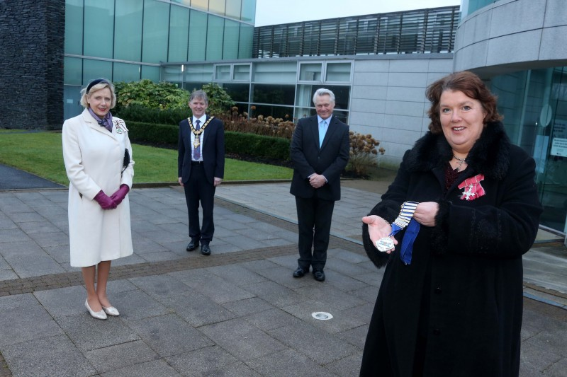 The new High Sheriff of County Londonderry, Paula McIntyre MBE, accepts the Chain of Office at Cloonavin as the Lord Lieutenant of County Londonderry Alison Millar, Mayor of Causeway Coast and Glens Borough Council, Alderman Mark Fielding, and the outgoing High Sheriff Ross Wilson, look on.