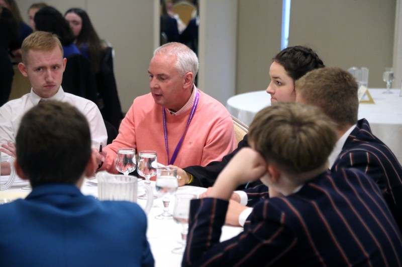 Councillor Dermot Nicholl pictured with pupils from local secondary schools at the ‘Let’s Talk’ event organised by Causeway Coast and Glens Good Relations Department.