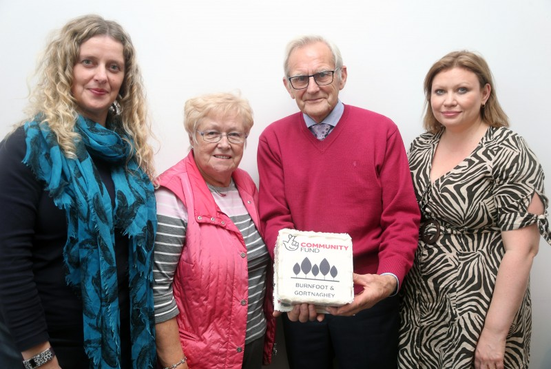 Catherine Farrimond, (Causeway Coast and Glens Borough Council Community Development Team), May Black (Burnfoot Seniors), Lyle Quigley (Burnfoot Community Association) and Adele McCloskey (Causeway Coast and Glens Borough Council Community Development Team) welcome the funding news along with a special cake to mark the occasion.