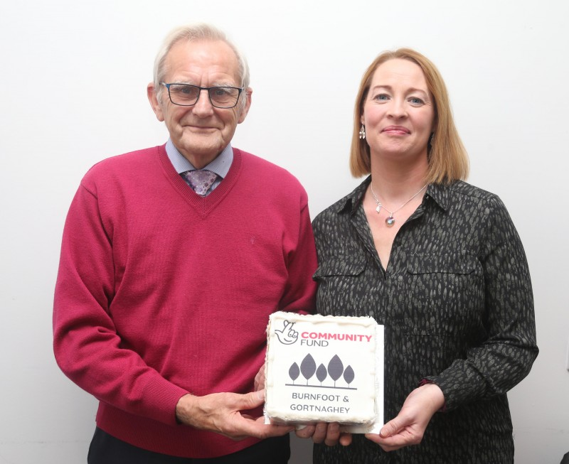 Lyle Quigley from Burnfoot Community Association and May Black from Burnfoot Seniors celebrate the funding news with a special cake to mark the occasion.