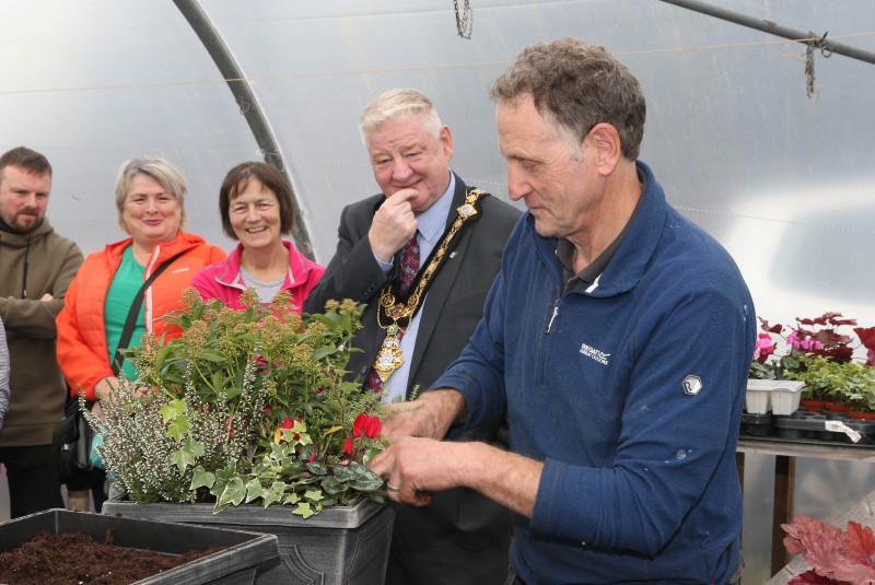 Andrew McClarty shows off a finished planter to, Move More Participants, family members and Mayor of Causeway Coast and Glens, Councillor Steven Callaghan.