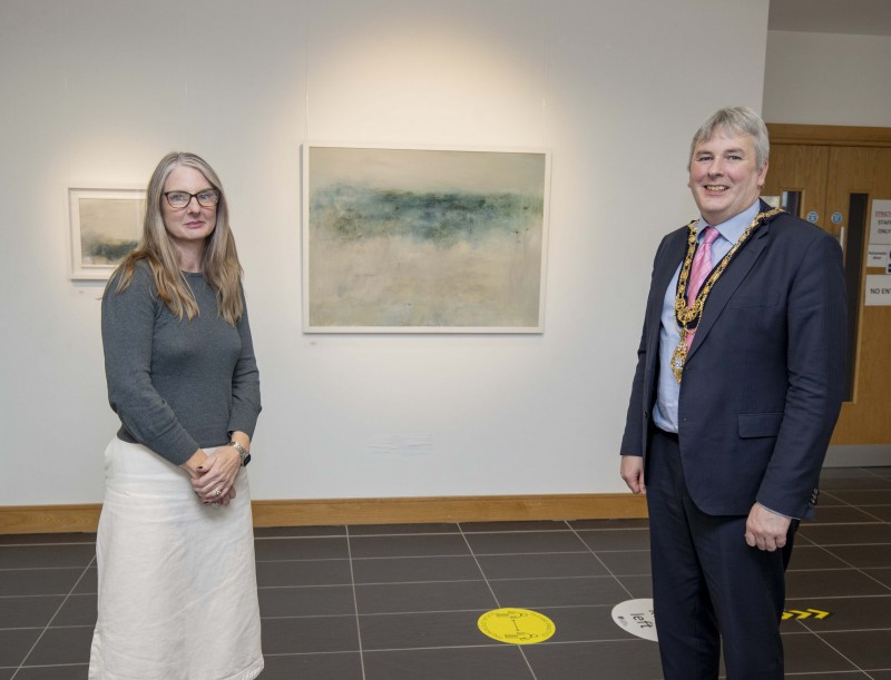 Artist Nicola Nemec shows the Mayor of Causeway Coast and Glens Borough Council Councillor Richard Holmes some of her work on display in the Beyond Edges exhibition at Roe Valley Arts and Cultural Centre.