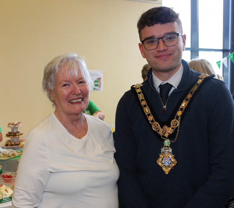 Mayor of Causeway Coast and Glens, Councillor Ciarán McQuillan greeting a guest at Council’s Macmillan Coffee Morning held in Portballintrae Village Hall.