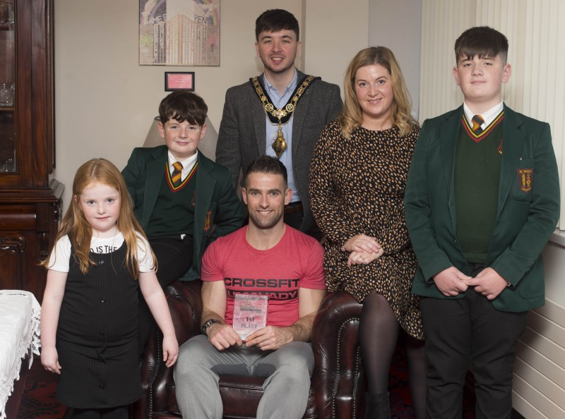 The Mayor of Causeway Coast and Glens Borough Council Councillor Sean Bateson pictured with Michael Walsh, at a recent reception to mark his success at the International Functional Fitness Federation IF3 World Championships in Australia, where he won the 35-39 age category. Also included is Michael’s wife Tilly and children Callum, Bobbie and Aleeyha.