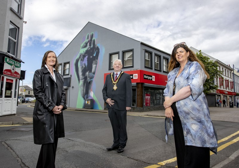 Department for Communities Officer Rhonda Williamson, Mayor of Causeway Coast and Glens Councillor Steven Callaghan and local artist Michelle McGarvey as they admire Coleraine’s town centre artworks.