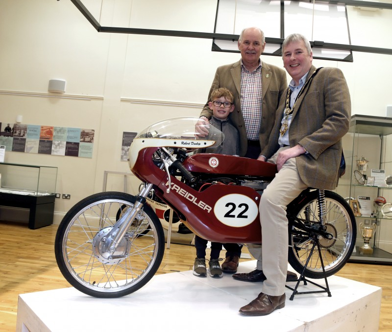 The Mayor of Causeway Coast and Glens Borough Council, Councillor Richard Holmes, recently visited the new ‘The Race and the Places’ exhibition at Ballymoney Museum. Joining the Mayor was Robert Dixon and his grandson, Bobby Acheson.