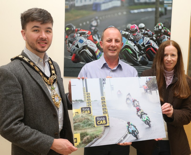 The Mayor of the Causeway Coast and Glens Borough Council, Councillor Sean Bateson pictured with Fergus Mackay, Event Operations Manager of the NW200 and Jane Blakely, winner in the Open Category in this year’s ‘Capture the Moment’ International NW 200 photography competition.