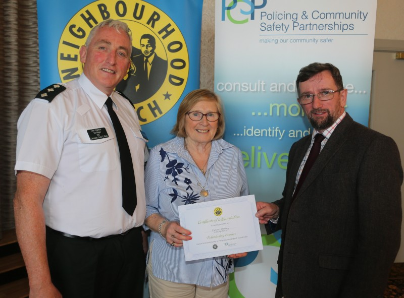 Celine Harvey pictured receiving her award for over ten years’ service as a Neighbourhood Watch co-ordinator with Chief Inspector Ian Magee and PCSP Chairperson Alderman George Duddy.