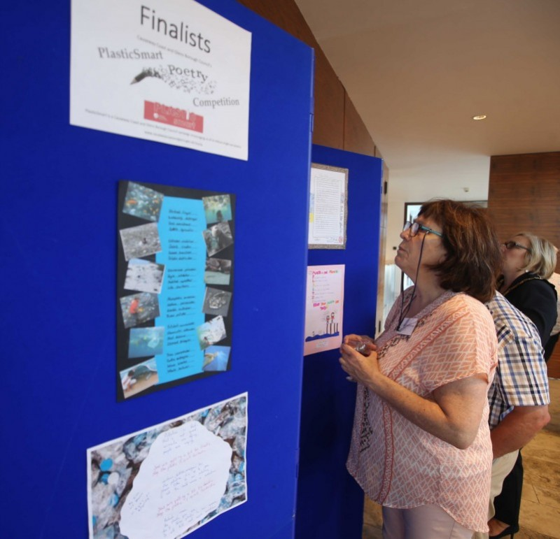 Admiring the finalists work in the PlasticSmart poetry competition.