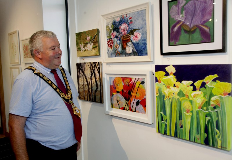 The Mayor of Causeway Coast and Glens Borough Council Councillor Ivor Wallace views some of the pieces created by members of the Limavady Art Group which are now on display at Roe Valley Arts and Cultural Centre.