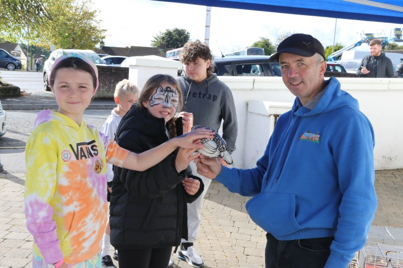 A group of children getting up close to the animals from Corbally Mobile Fun Farm.