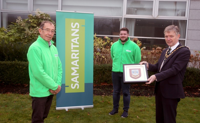 The Mayor of Causeway Coast and Glens Borough Council Alderman Mark Fielding presents a framed Coat of Arms to David McKeown and Colin Taylor to mark 50 years of the Coleraine & District Branch.