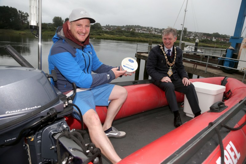 Matt Wright from Causeway Coasteering shows a margarine tub from Newfoundland, Canada, found amongst waste beneath Dunluce Castle, to Causeway Coast and Glens Borough Council Mayor, Alderman Mark Fielding