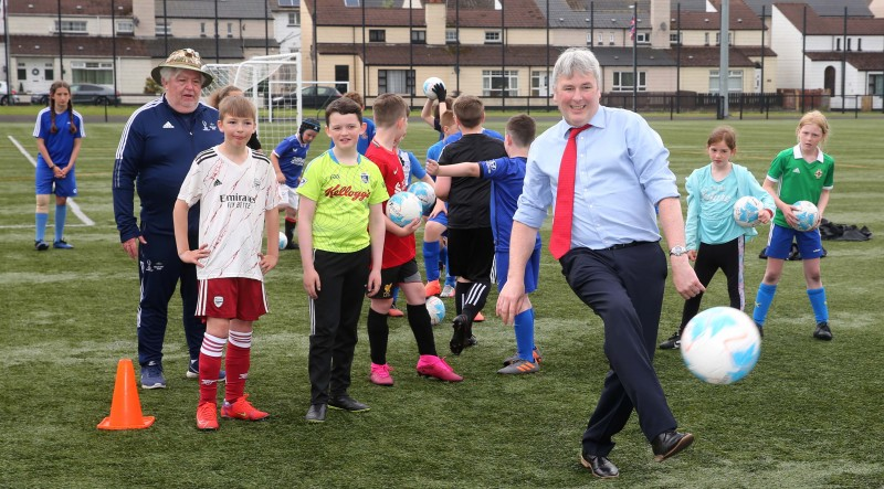 Mayor of Causeway Coast and Glens Borough Council, Councillor Richard Holmes shows off his skills with young players at the football camp at Scroggy Road.