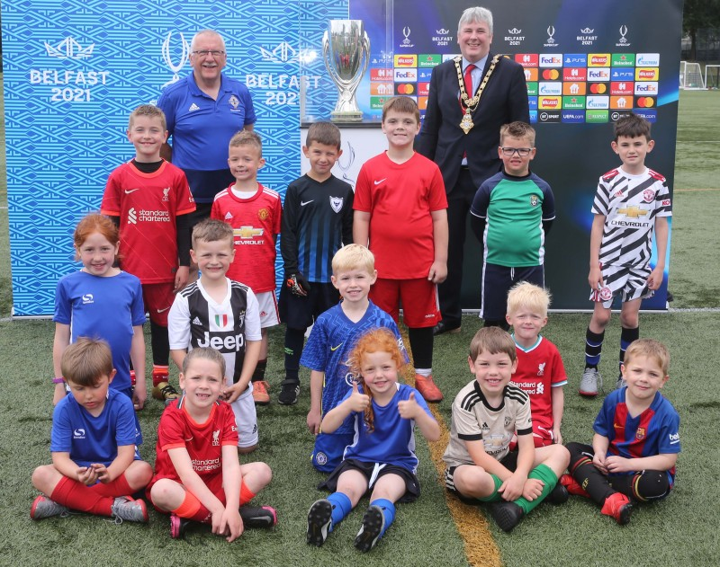 Mayor of Causeway Coast and Glens Borough Council, Councillor Richard Holmes and young players with the UEFA Super Cup at the football camp hosted in partnership by Causeway Coast and Glens Borough Council and the Irish Football Association.