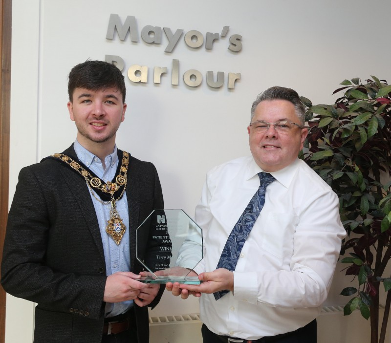 Terry McVeigh, a Macmillan Palliative Care Nurse Specialist at Causeway Hospital, pictured with the Mayor of Causeway Coast and Glens Borough Council Councillor Sean Bateson at a recent reception held in his honour. Terry was the winner of the Patients’ Choice Award at this year’s RCN Nurse of the Year Awards in recognition of his commitment and compassion towards patients with palliative care needs and their families.