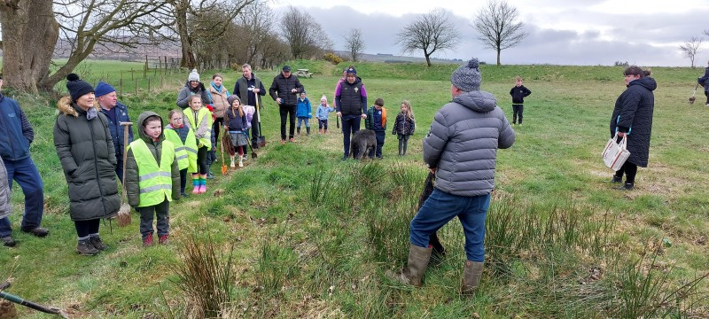 Gerry Burns holding a group discussion on the history of Limepark in Armoy with volunteers who were tree planting.