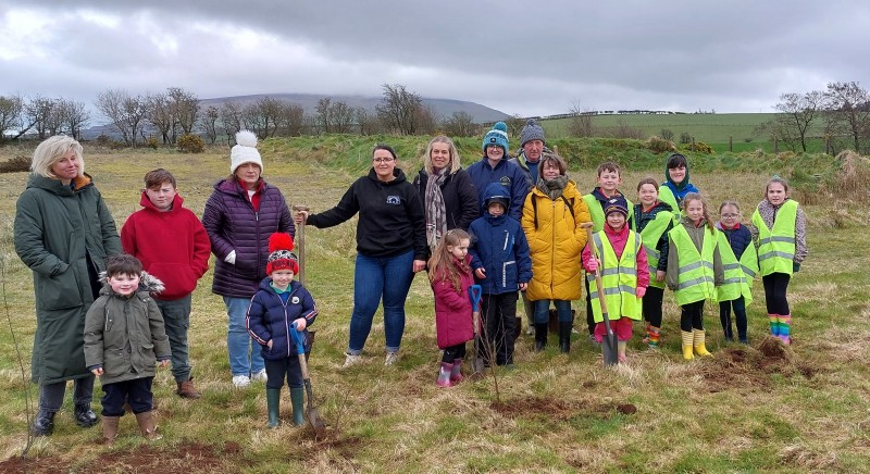 Ruth McNeill and Gerry Burns from Armoy Community Association alongside children from Armoy Primary school, St Olcan’s Primary School and Armoy Cross Community Playgroup, planting native trees in Limepark in Armoy.