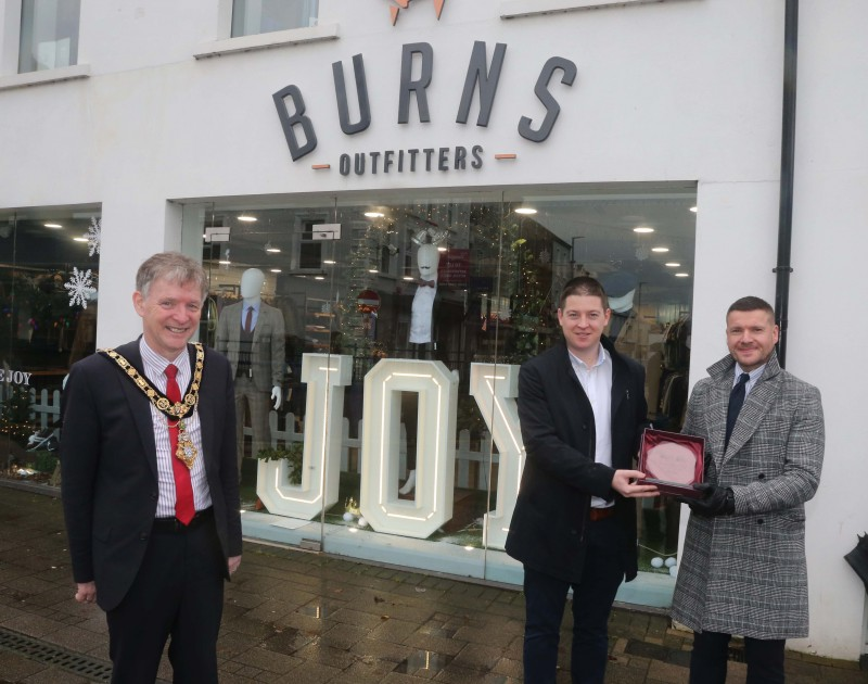 Burns Outfitters was the winner of the Best Christmas Window in Coleraine and the Mayor of Causeway Coast and Glens Borough Council Alderman Mark Fielding presented the award to Jamie Burns and Michael Moffatt .