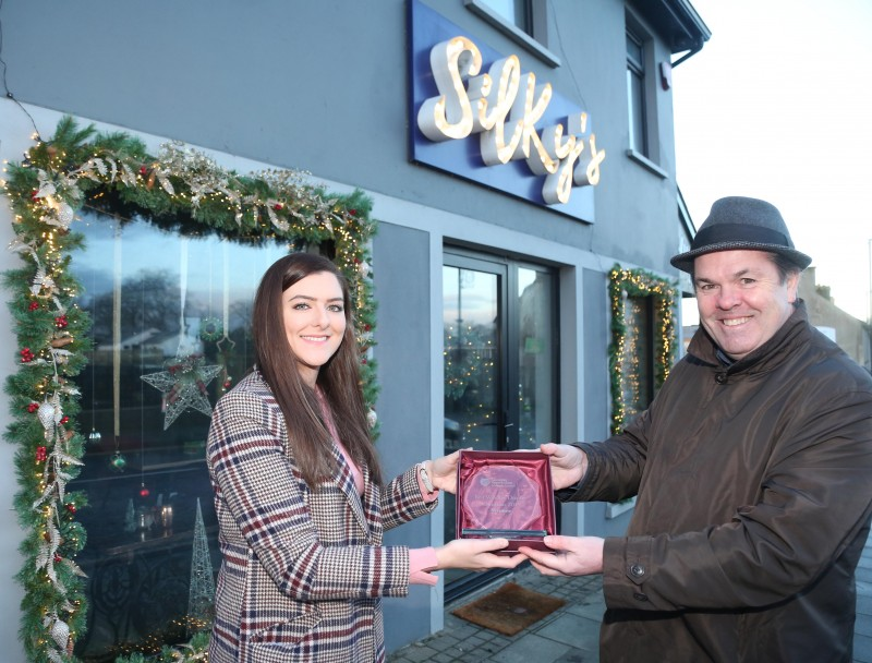 Silky’s Bistro on Main Street Dungiven was the winner of Causeway Coast and Glens Borough Council’s Christmas window competition in Dungiven. Rachael O’Connor is pictured receiving the award from Town and Village Officer Shaun Kennedy.