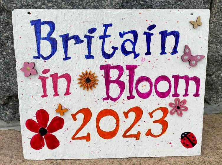 A wonderful slate hand painted sign on display in the Diamond, Coleraine, made by The Crafty Cuppa Club to celebrate Coleraine’s Britain in Bloom large town entry in Britain in Bloom 2023.