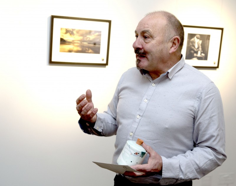 Harry Coates, Festival board member, congratulates the winner of the photography competition.