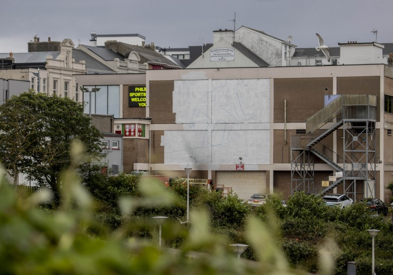 2 A mural of a surfer by artist Aches starts to take shape on a wall overlooking East Strand in Portrush as part of a wider scheme to increase the vibrancy of our town centres.