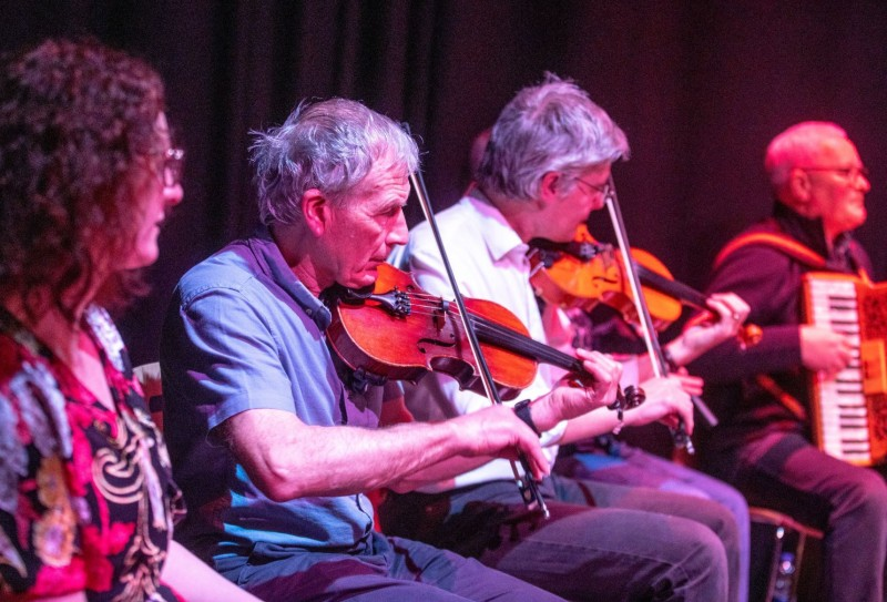 Donal O’Donnell from Comhaltas Ghlinntí Aontroma alongside some of the tutors involved in the Shared Music of Dalriada performance.