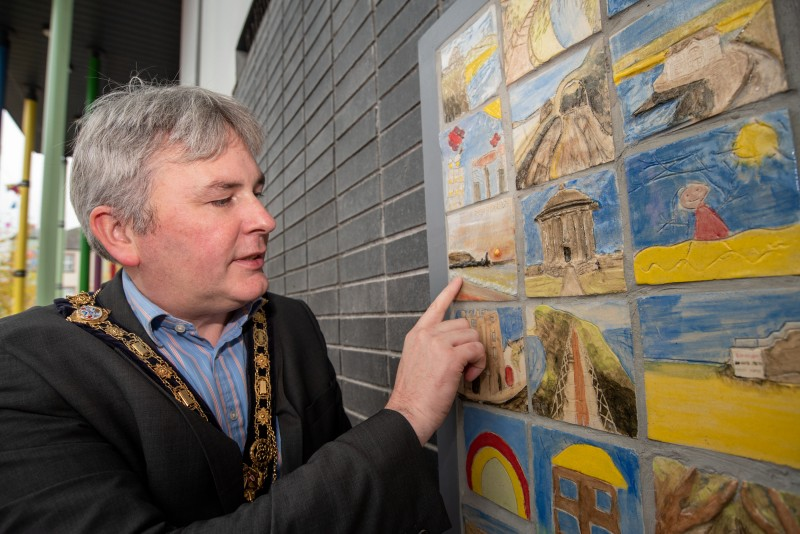 The Mayor of Causeway Coast and Glens Borough Council, Councillor Richard Holmes views the tiles created as part of the ‘Our Story in the Making’ community artwork at Roe Valley Arts and Cultural Centre.