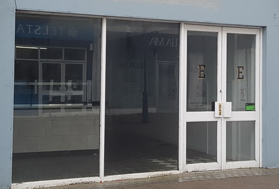 The vacant shop in Coleraine town centre before its windows were used as a canvas for a colourful artwork featuring Causeway Speciality Market.