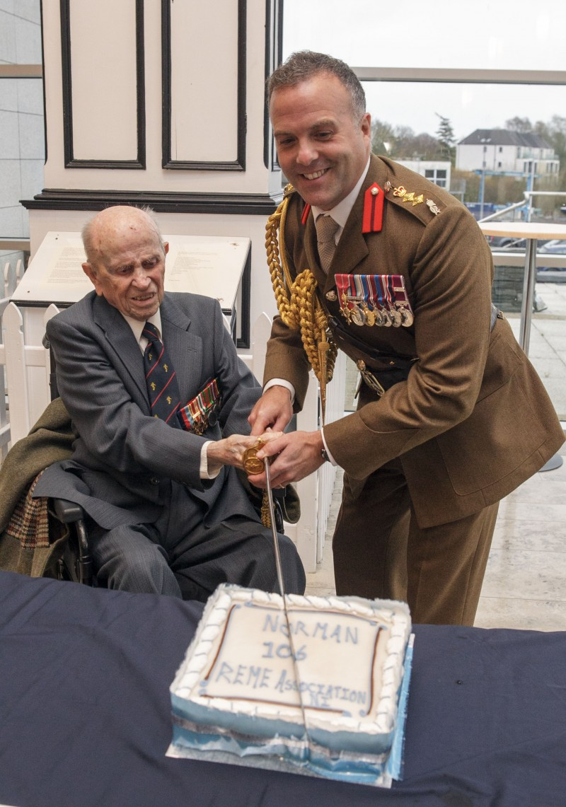 Norman Irwin cuts his 106th birthday cake with REME Corps Colonel, Colonel Iain Wallace OBE ADC CEng, at reception held in Council’s Civic offices Cloonavin this week.