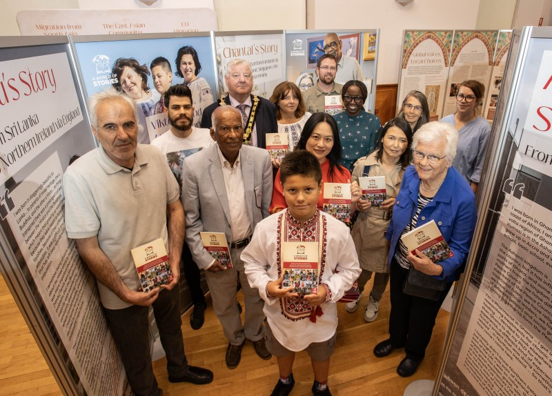 Mayor of the Causeway Coast and Glens Borough Council, Councillor Steven Callaghan with A World of Stories participants and Museum Services staff at the exhibition in Coleraine Town Hall.