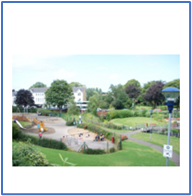 A park with a playground and a group of people